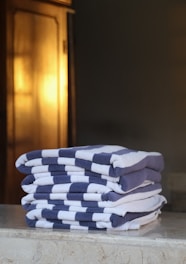 a stack of folded towels sitting on top of a counter