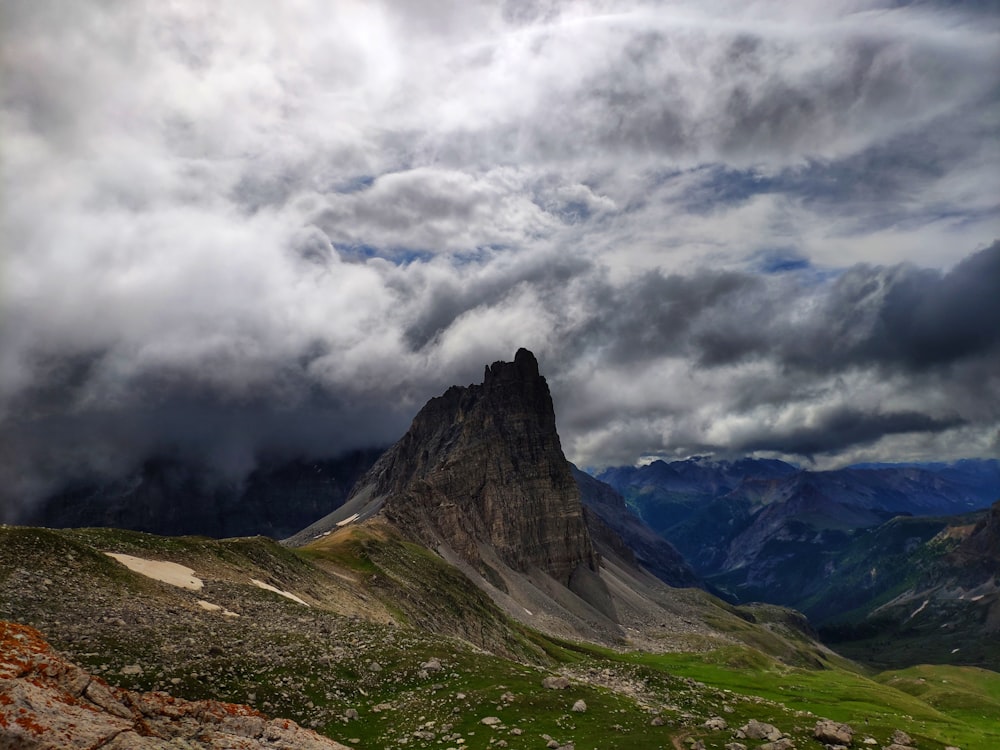 a mountain range with a cloudy sky in the background