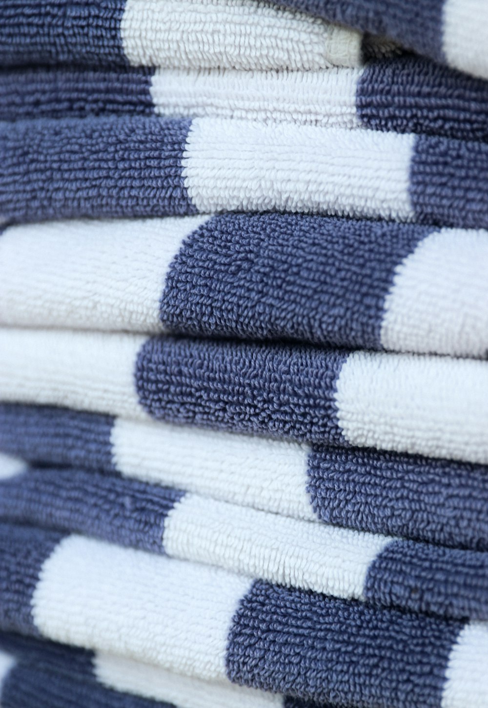 a stack of blue and white towels stacked on top of each other