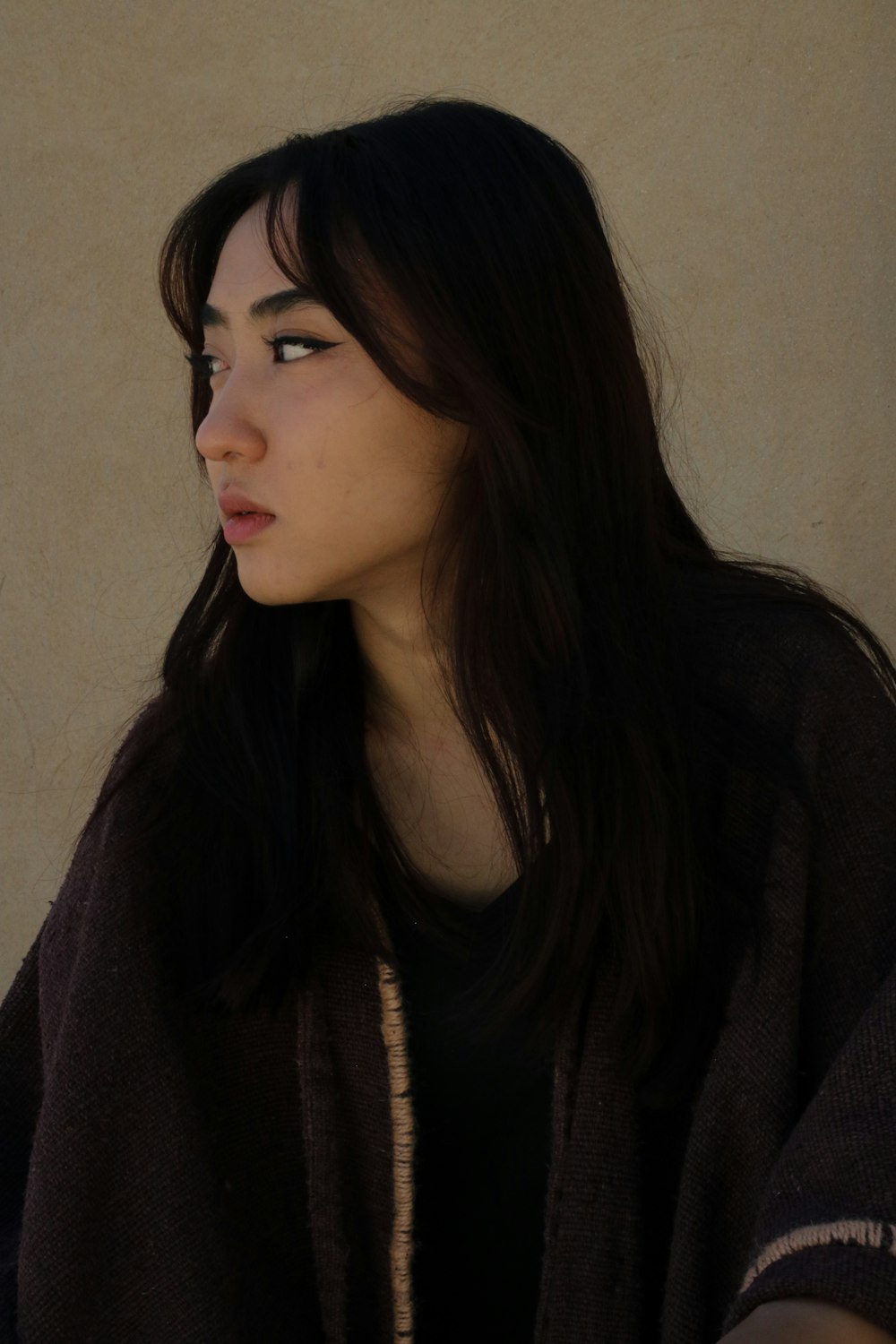 a woman with long dark hair and a black shirt