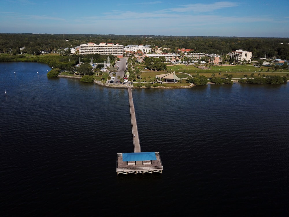 an aerial view of a body of water with a dock