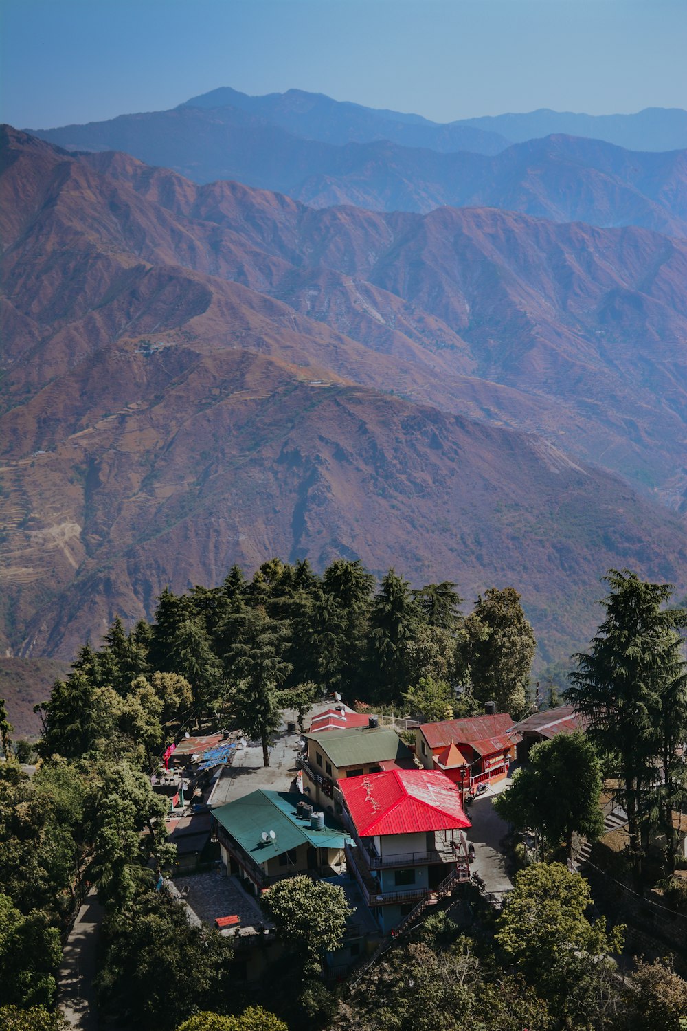 a view of a mountain range with houses in the foreground