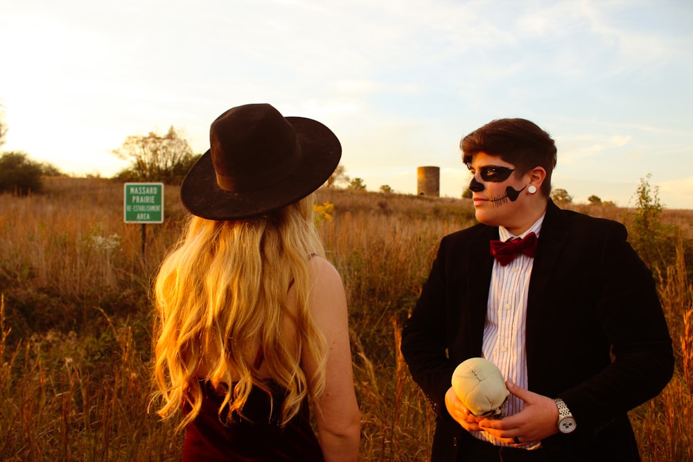 a man in a tuxedo talking to a woman