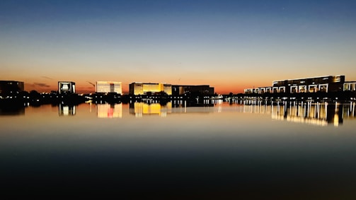 A stunning water view with highrise buildings reflecting the sunset, representing home evaluations.