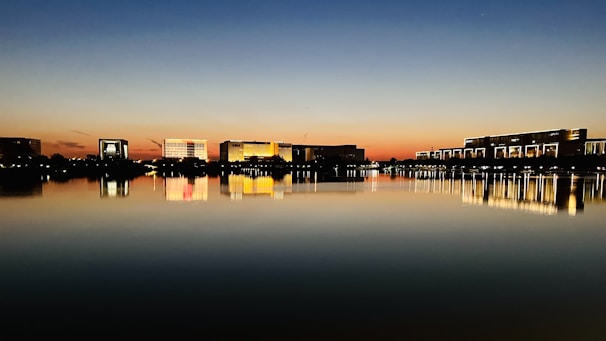 A stunning water view with highrise buildings reflecting the sunset, representing home evaluations.