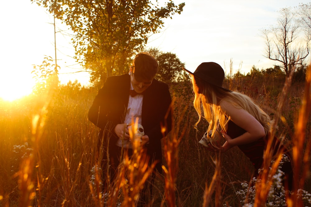 a couple of people standing in a field