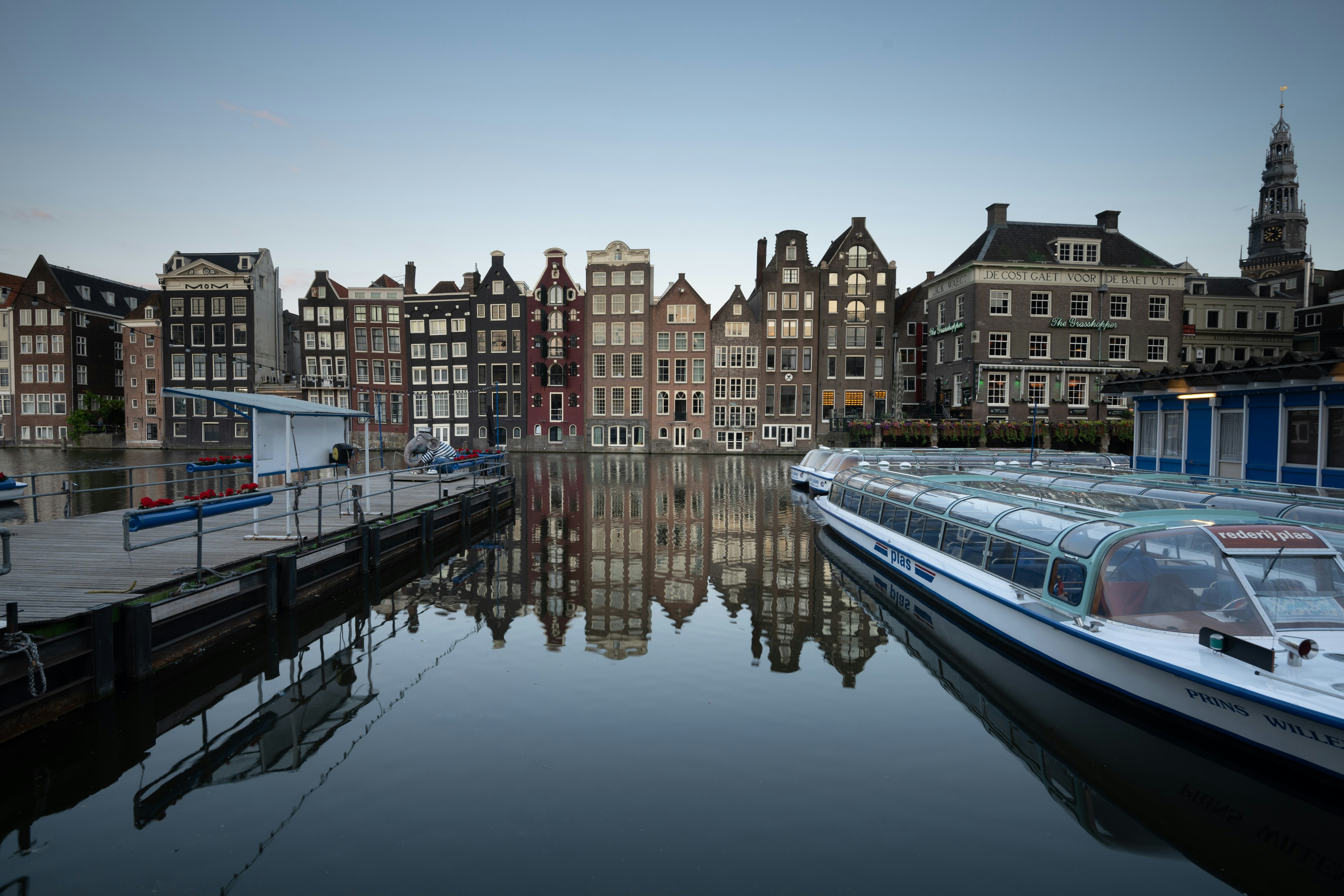 a row of boats sitting next to a body of water