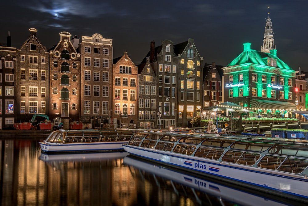 a row of boats sitting next to each other on a river