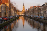 Taxi waiting by a canal bridge in Amsterdam during sunset