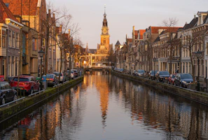 Taxi waiting by a canal bridge in Amsterdam during sunset
