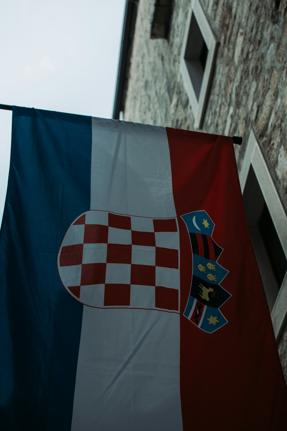 a flag hanging from the side of a building