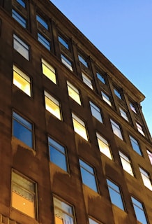 Exterior view of 125 Cherry Street building at dusk with glowing windows