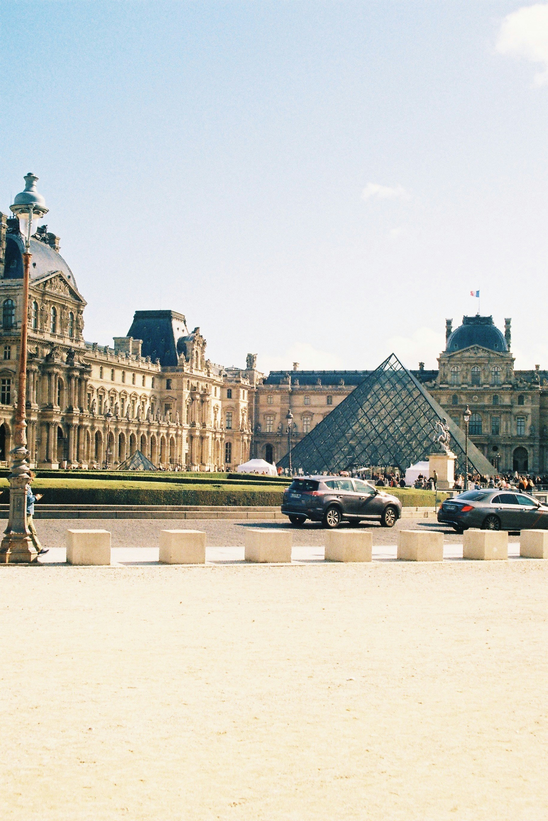 a man riding a skateboard down a street next to a tall building