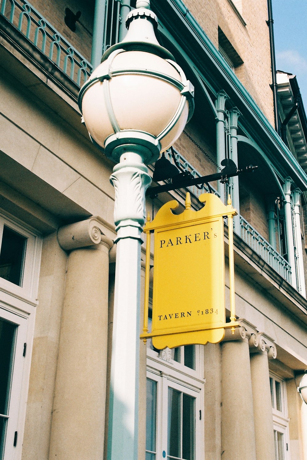 a lamp post with a sign on it in front of a building