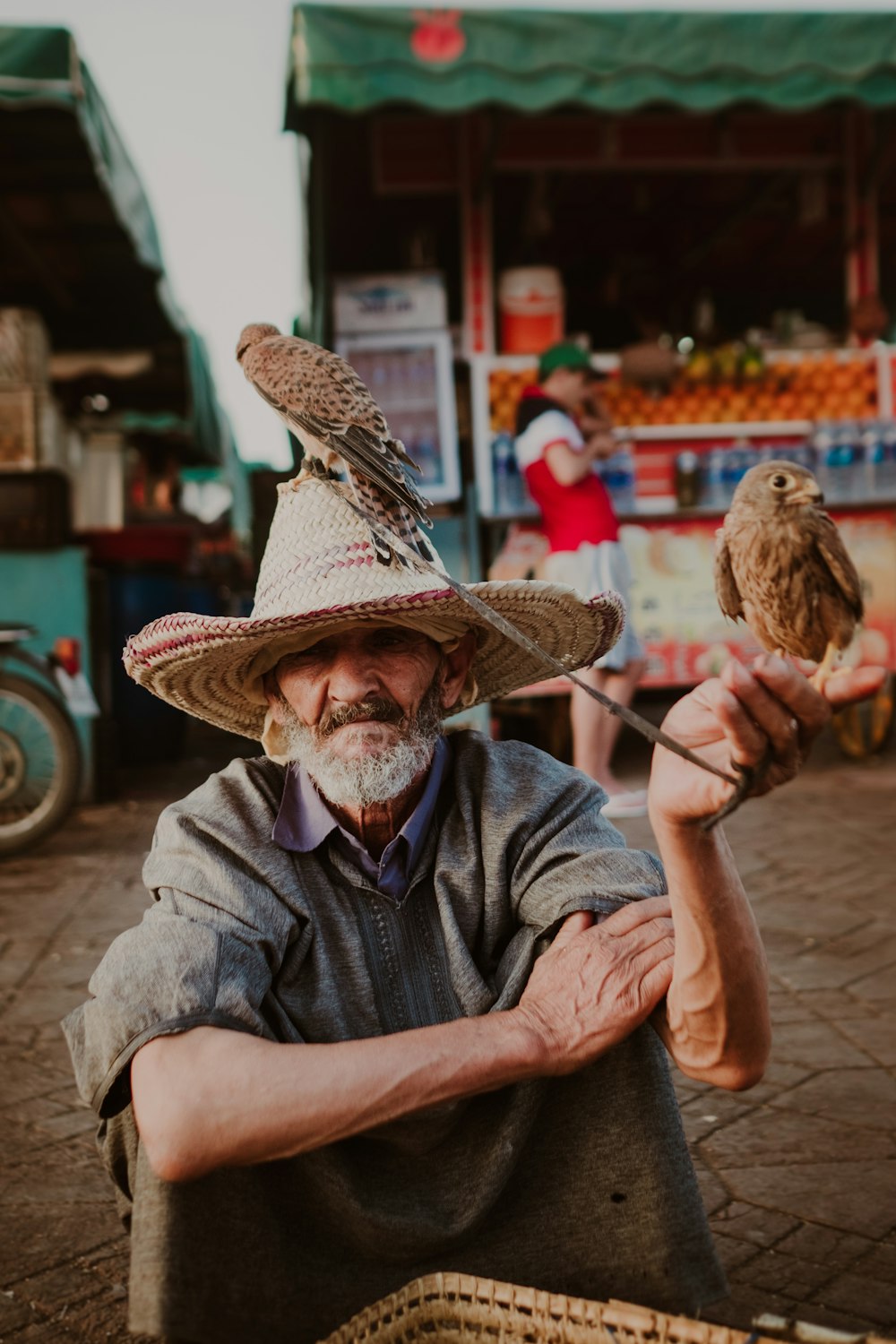 a man holding a bird on his arm