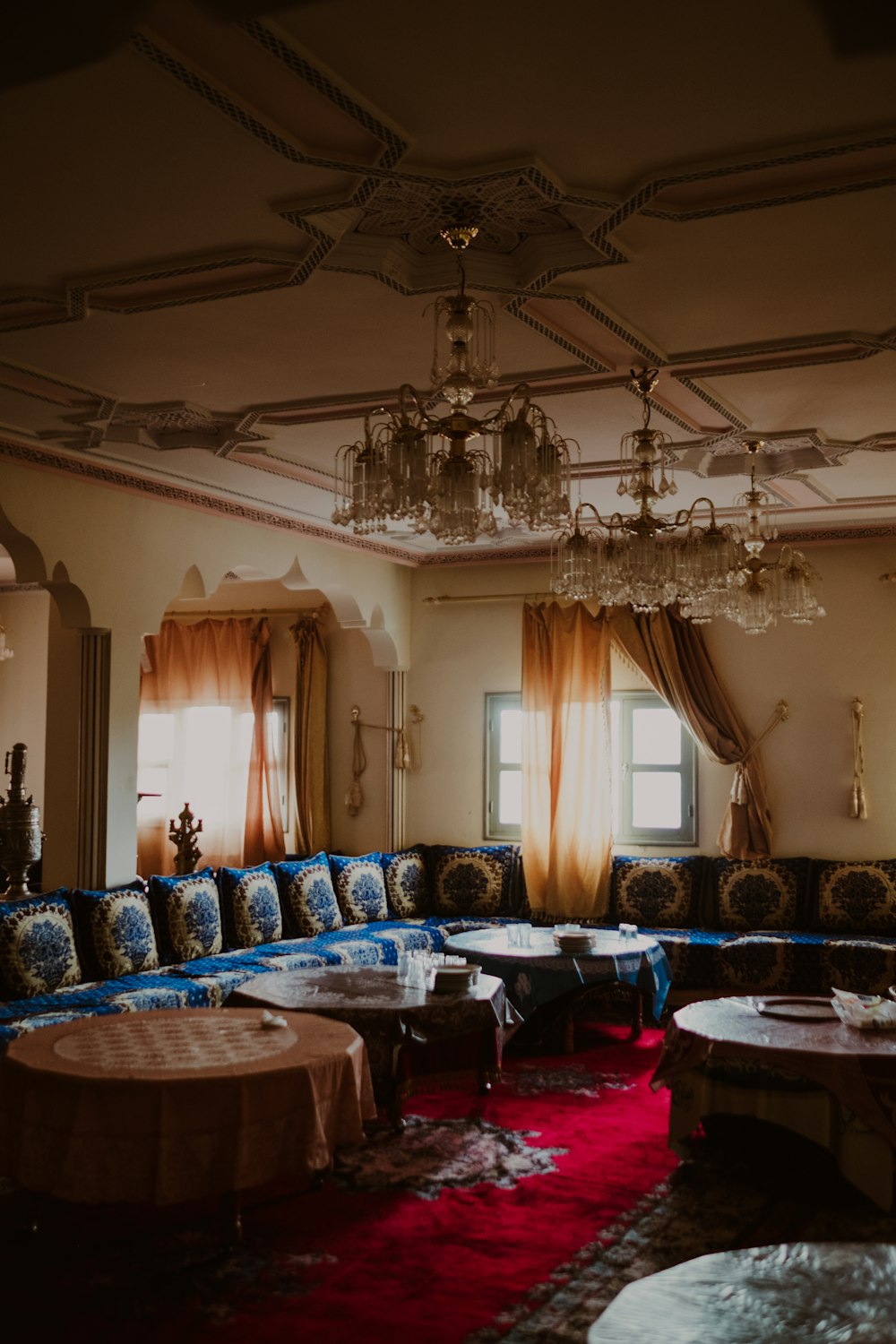 a living room filled with furniture and a chandelier