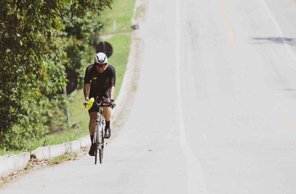 a man riding a bike down a street