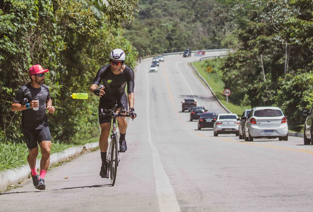 a couple of people riding bikes down a road