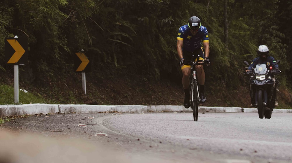 a man riding a bike down a curvy road