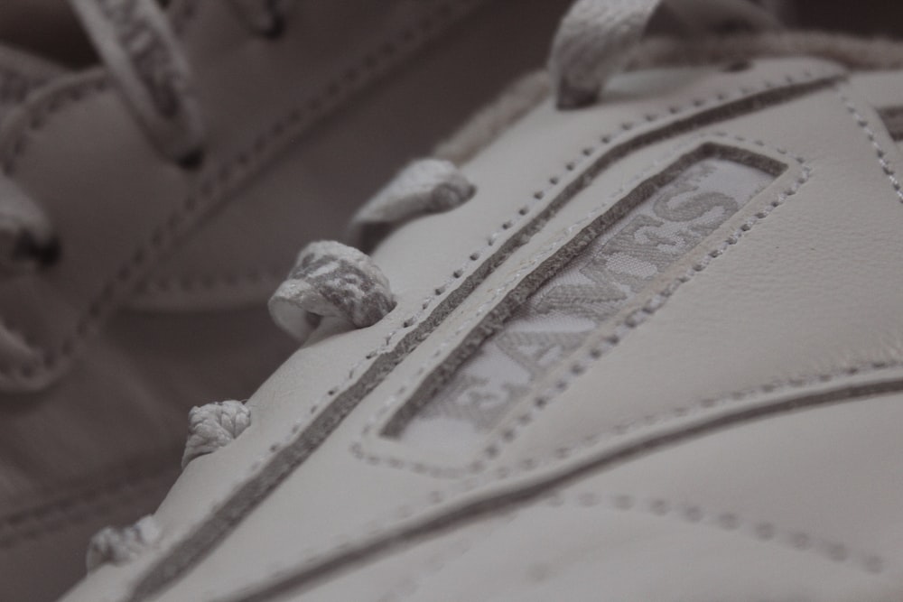 a close up of a baseball glove with a white and gray design