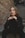 a woman sitting on the steps in front of a brick wall