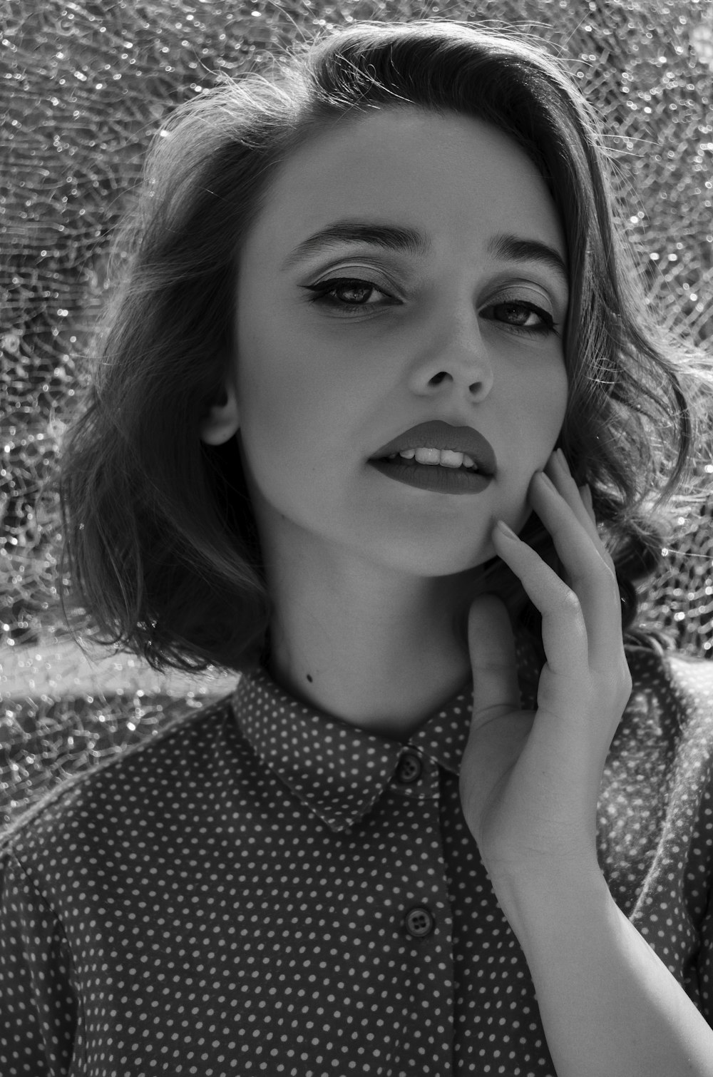 a black and white photo of a woman talking on a cell phone