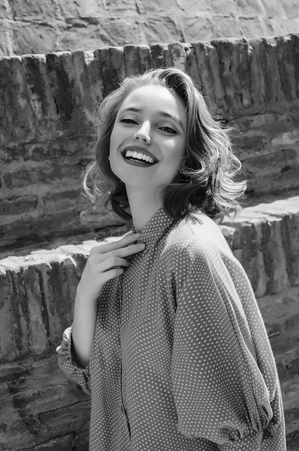 a black and white photo of a woman smiling