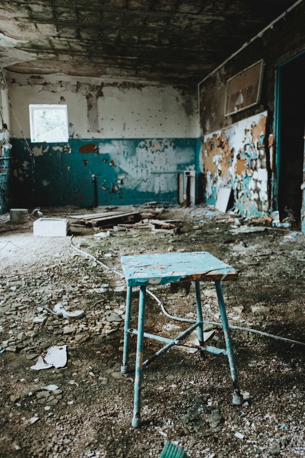 an old run down room with a broken table