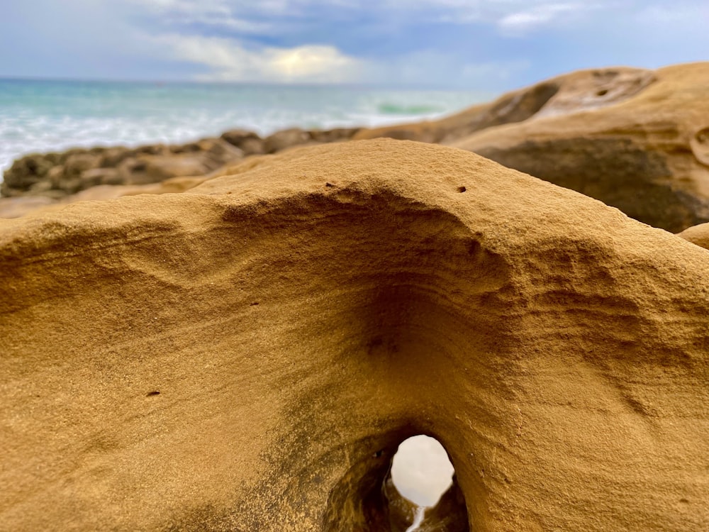 a close up of a rock formation near the ocean