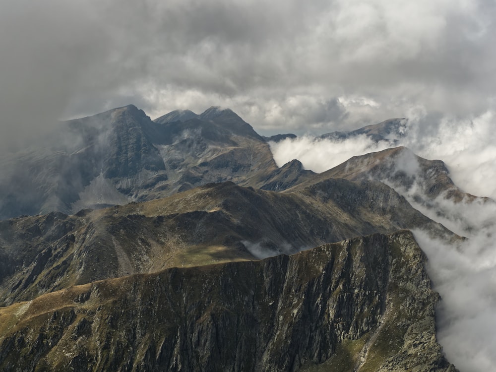 a view of a mountain range covered in clouds