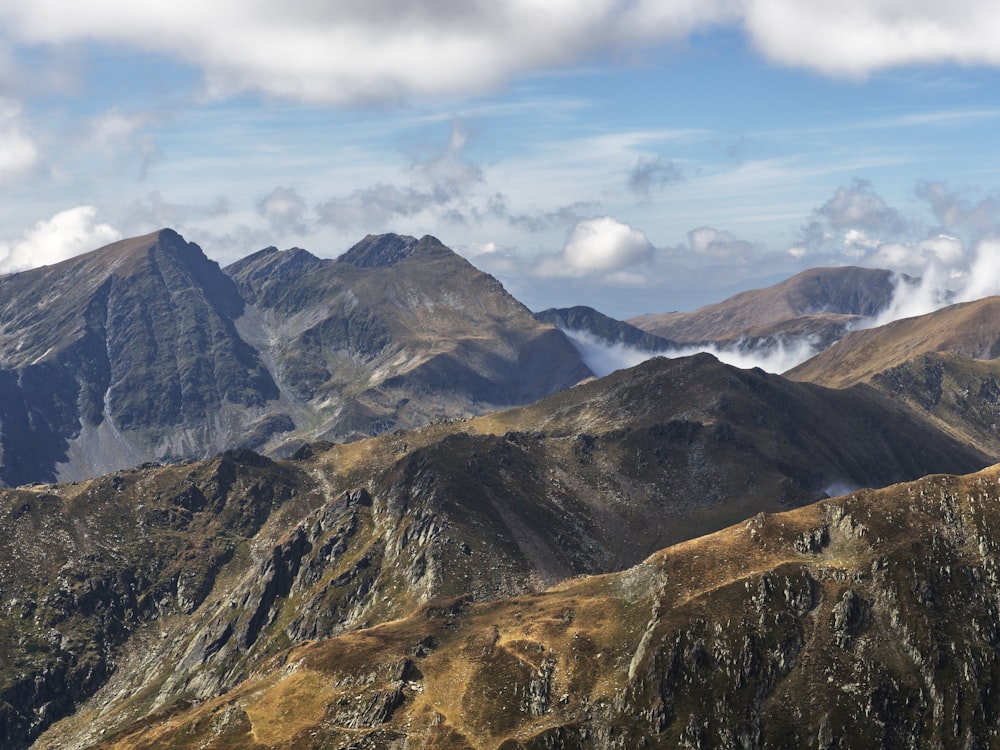 a view of a mountain range with clouds in the sky