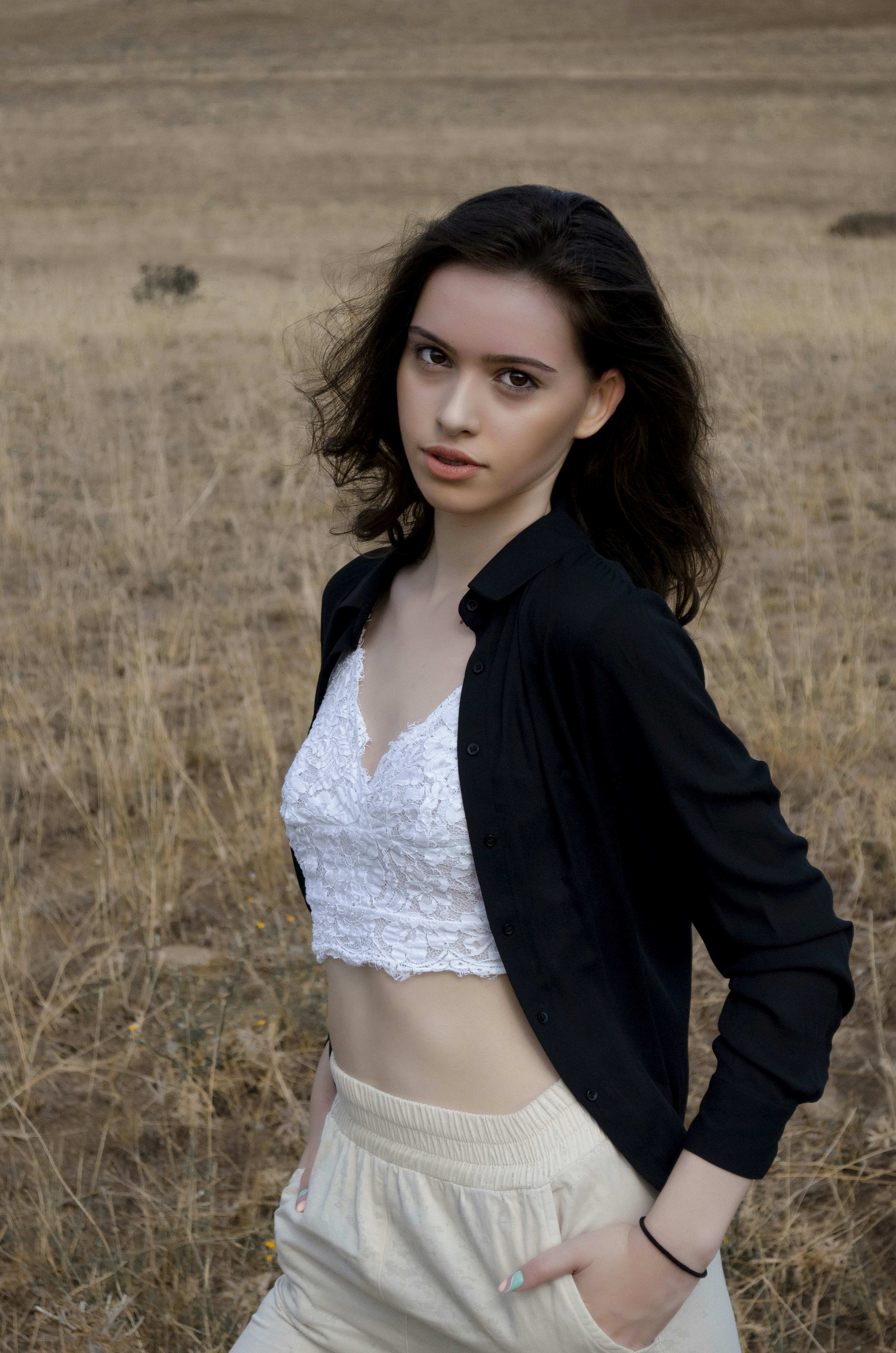 A woman standing in a field with her hands on her hips photo – Free ...