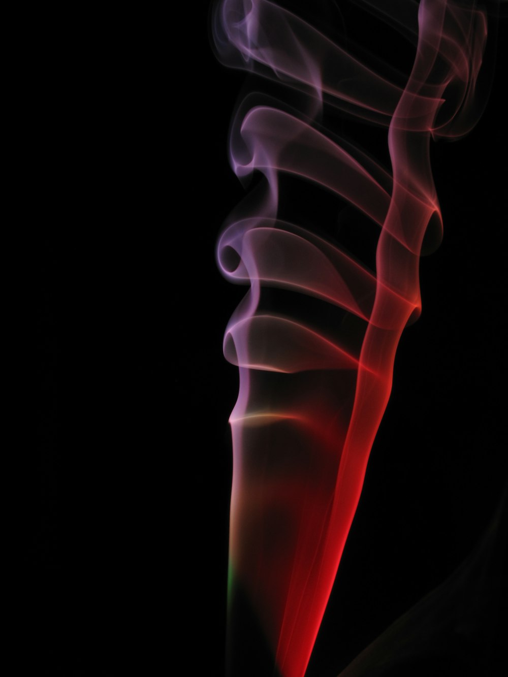 a red and purple smoke stack on a black background