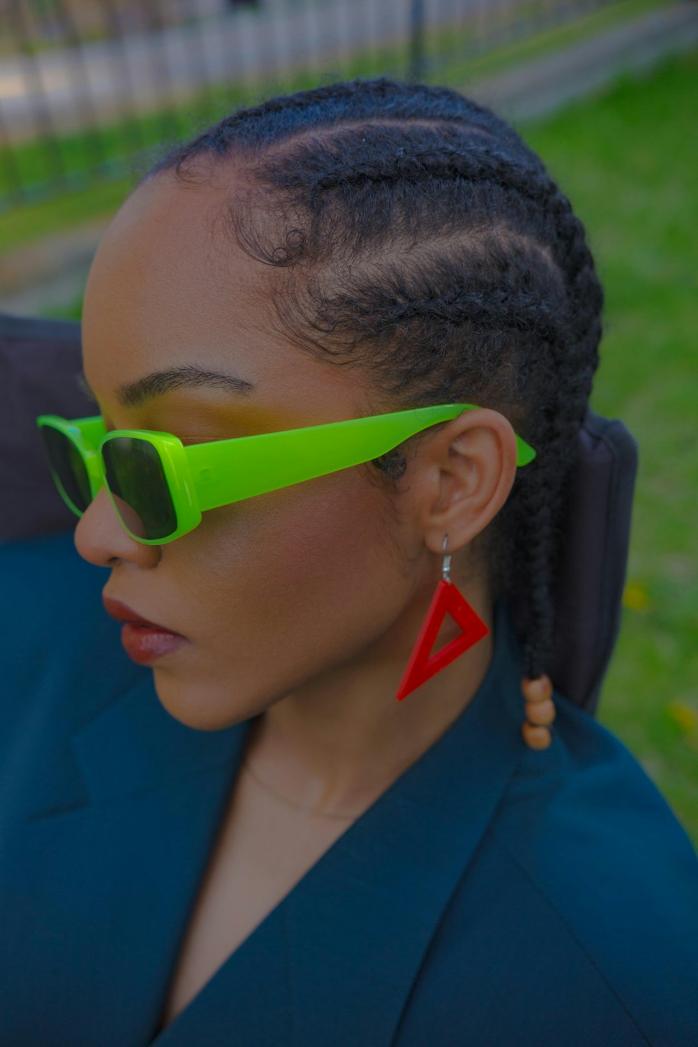 a woman wearing a pair of neon green sunglasses