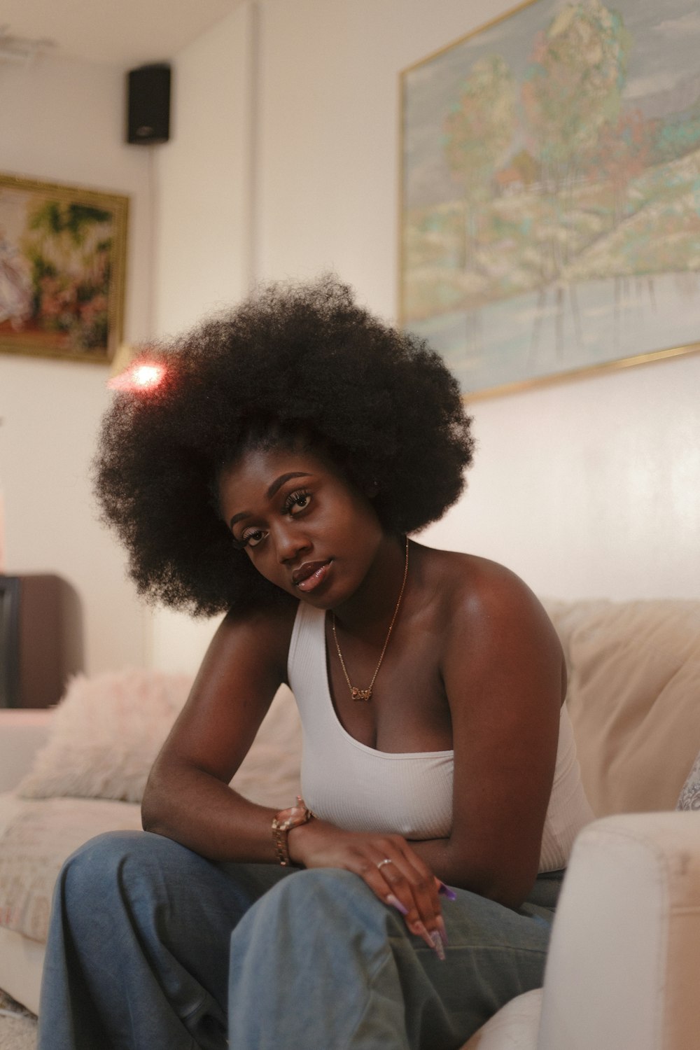 a woman with an afro sitting on a couch