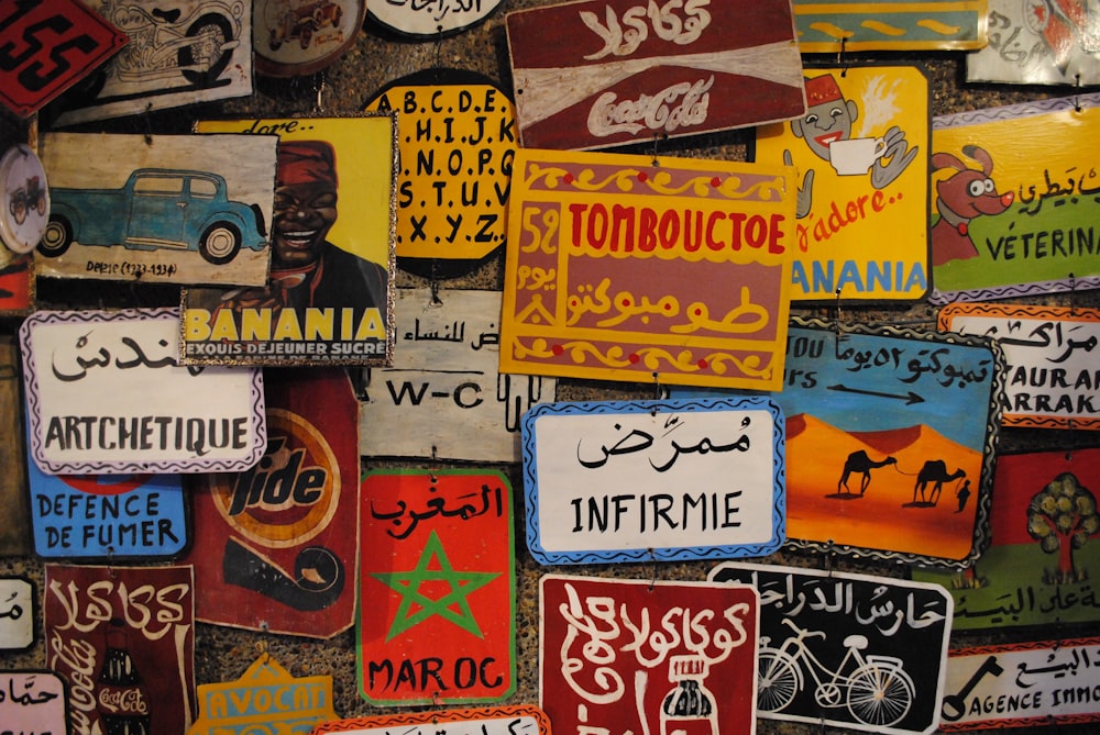a wall covered in lots of different types of signs