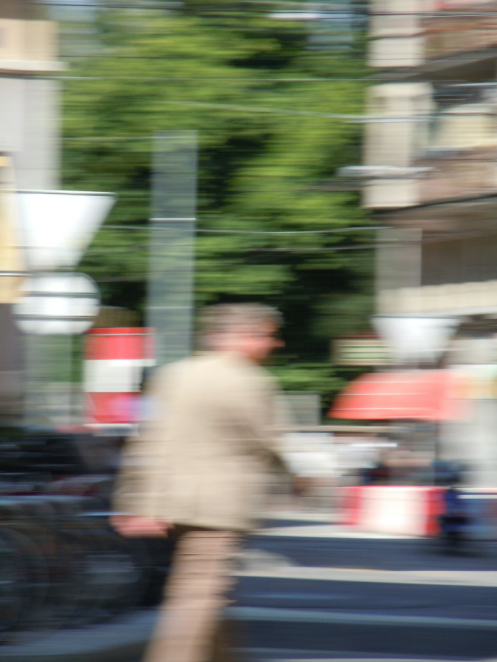 a blurry photo of a man walking down the street