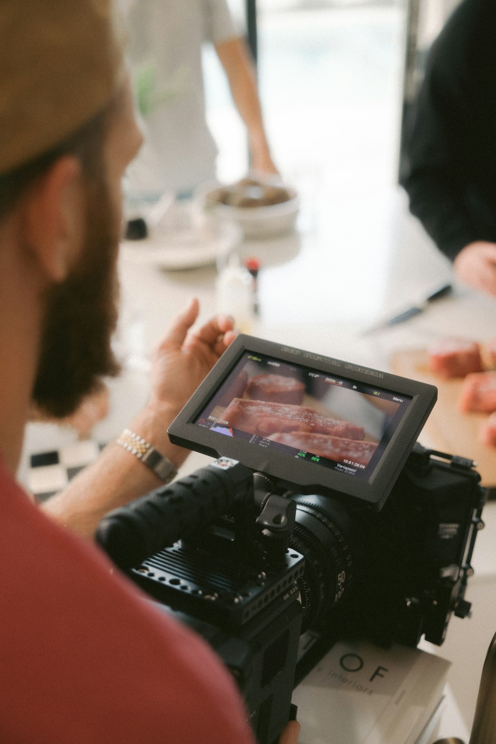 a man holding a camera and recording a video