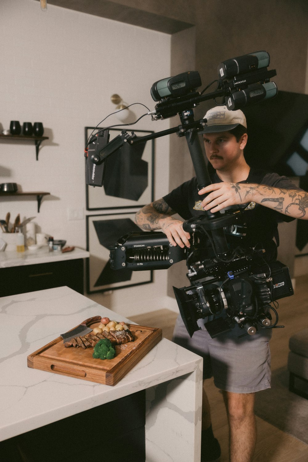 a man standing in a kitchen holding a camera