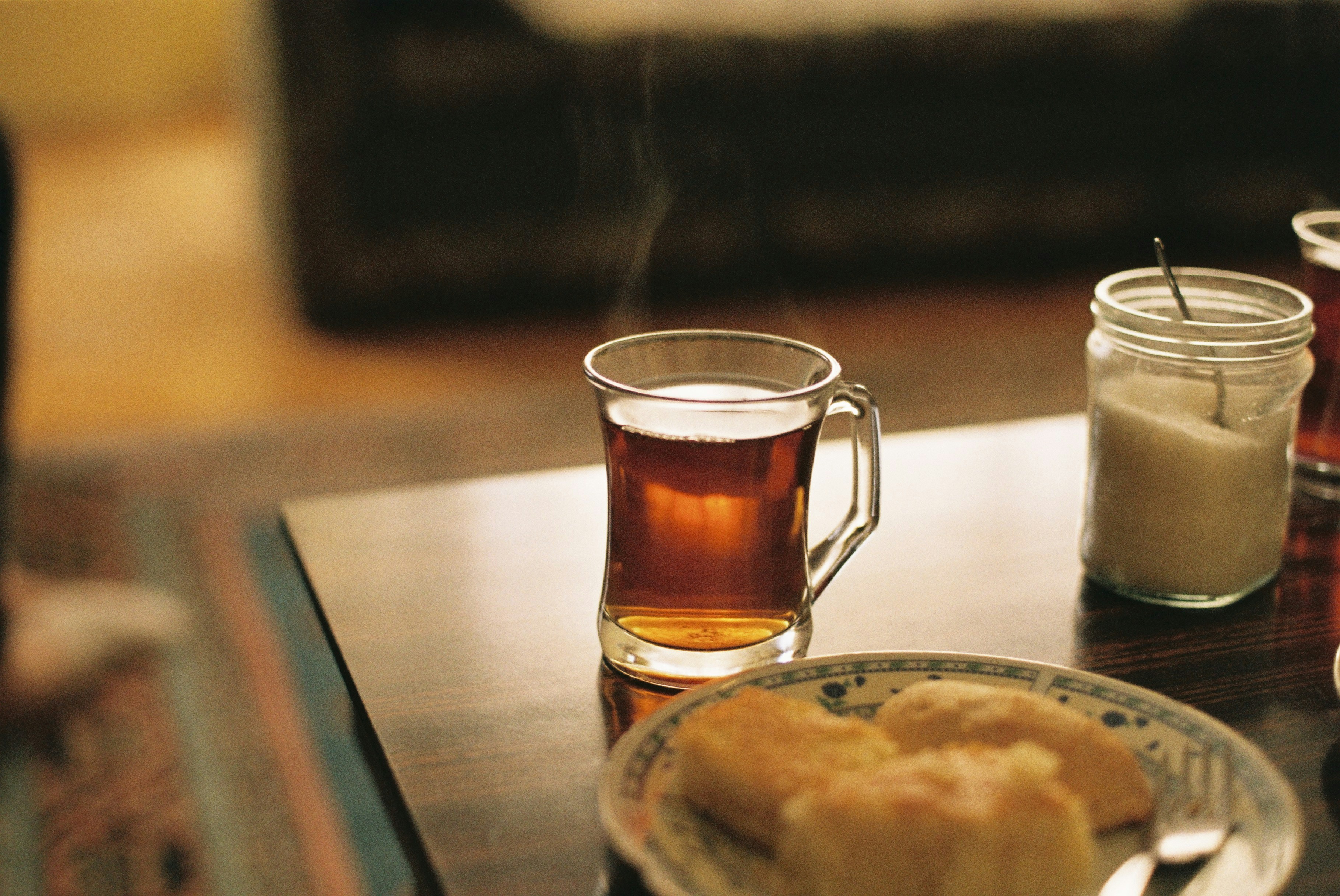 a table topped with a plate of food and a cup of tea
