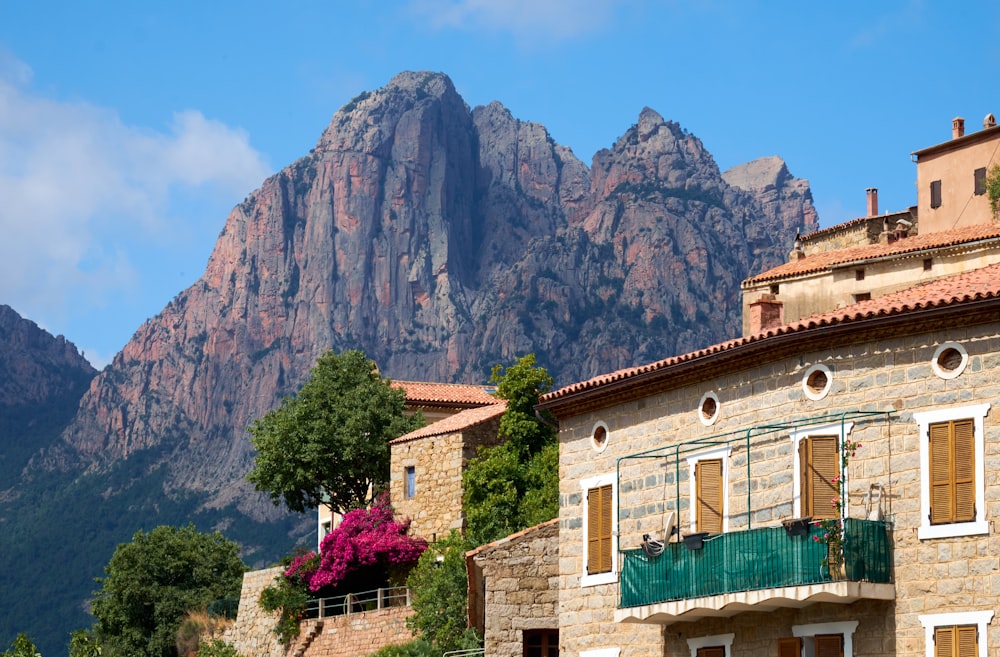 a mountain range is in the distance behind a row of buildings