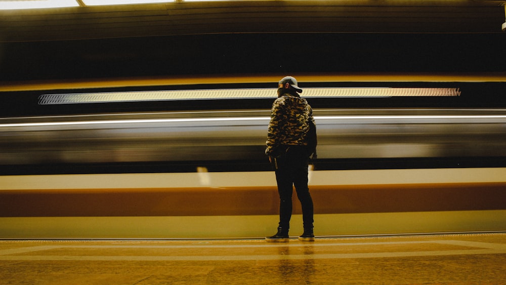 a person standing in front of a train