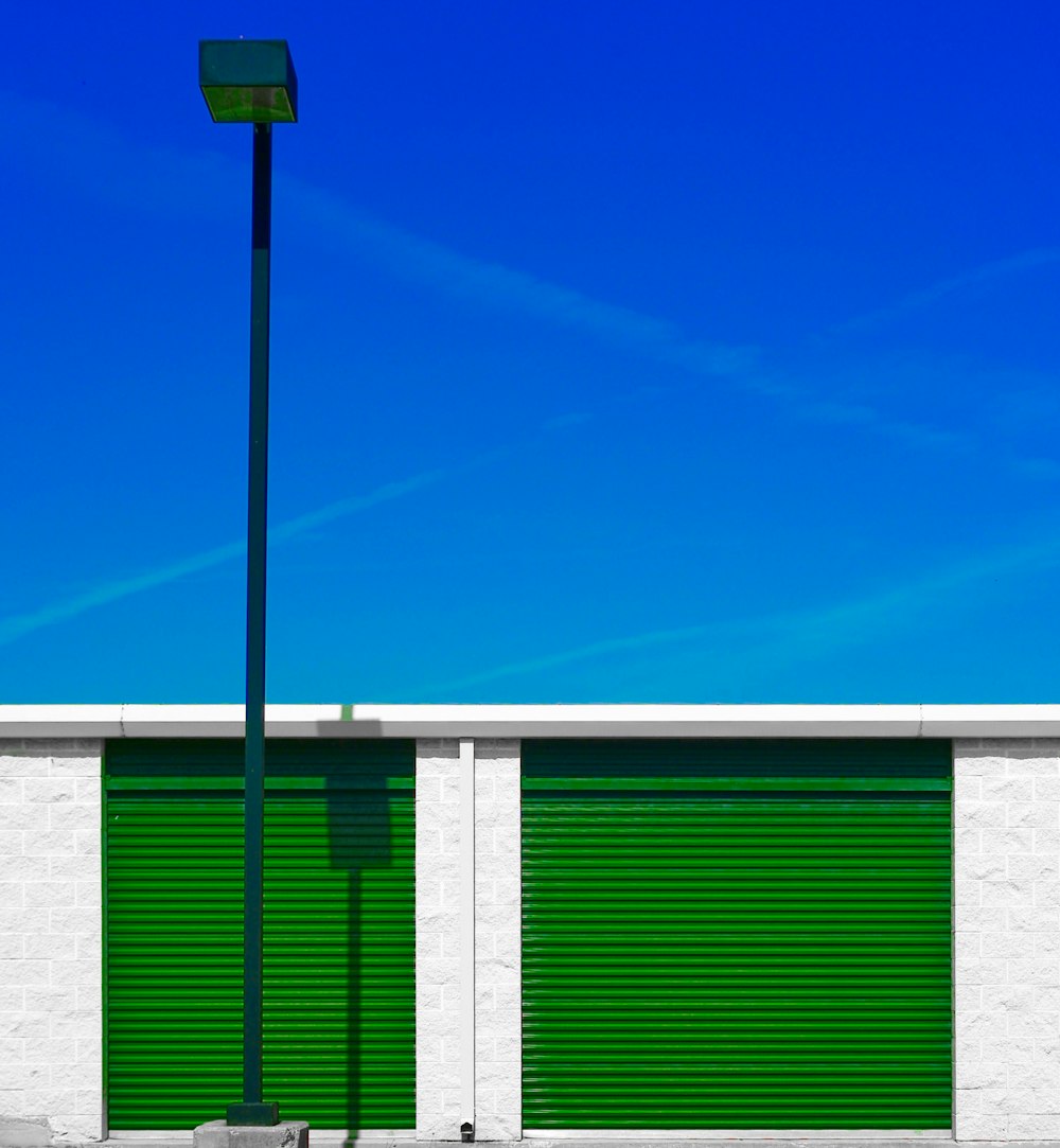 a street light next to a green roller door