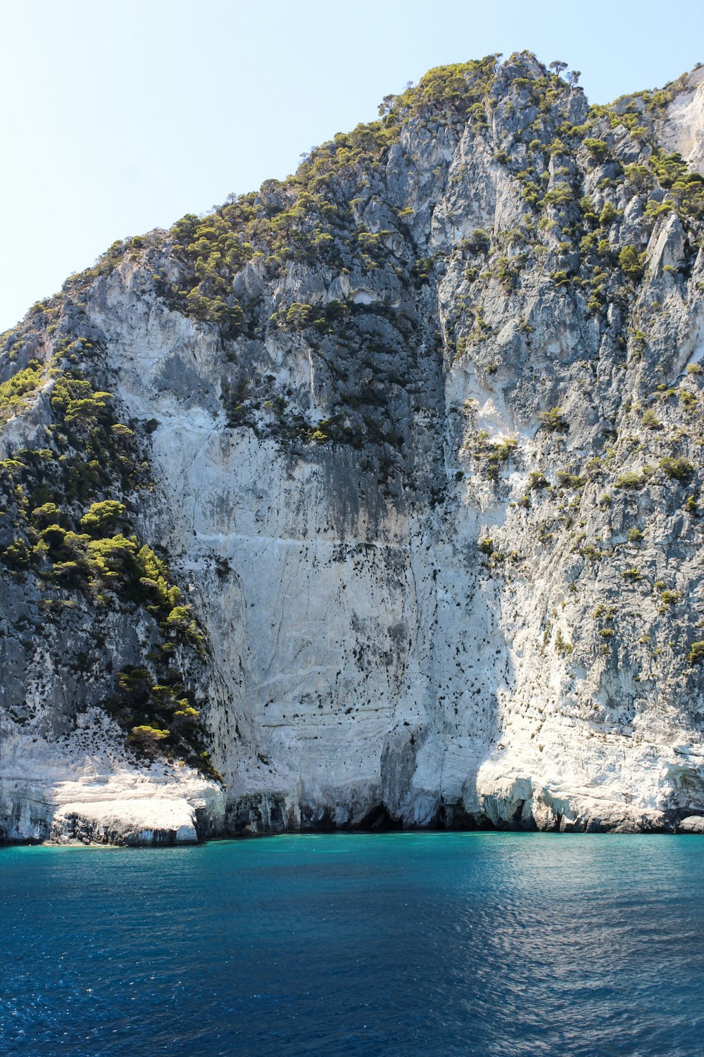 a boat is in the water near a mountain