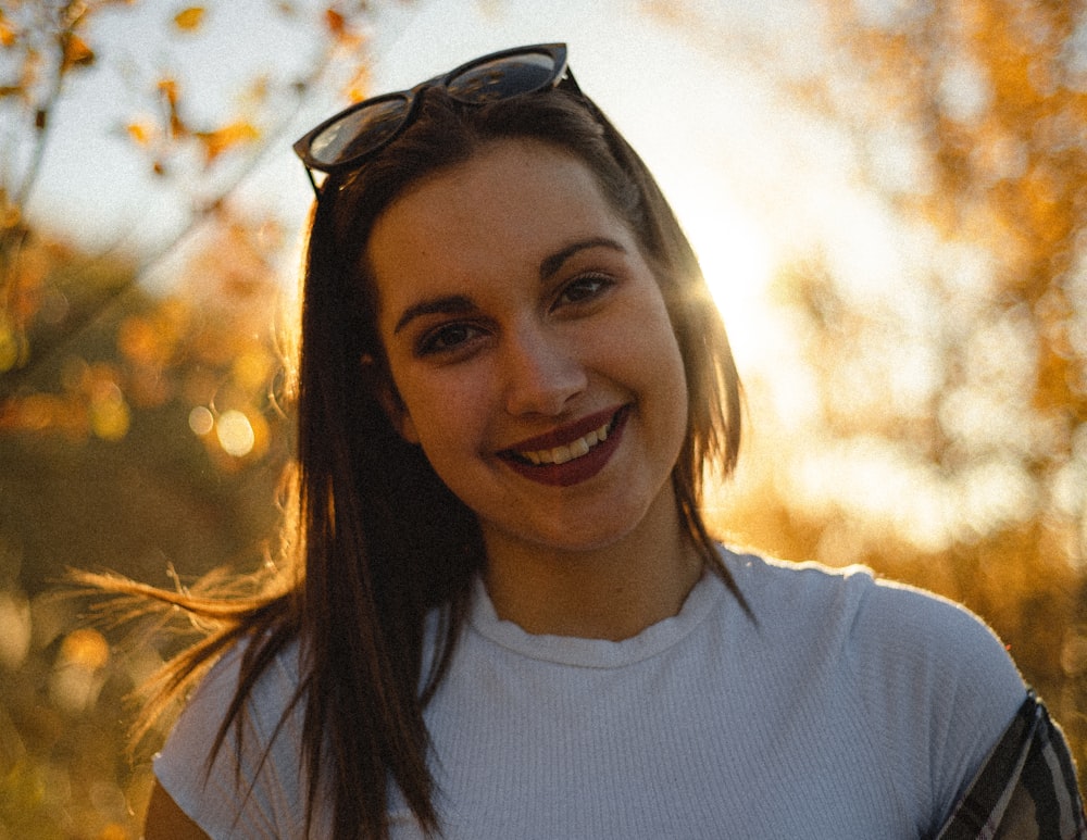 Eine Frau mit Sonnenbrille und Lächeln in die Kamera