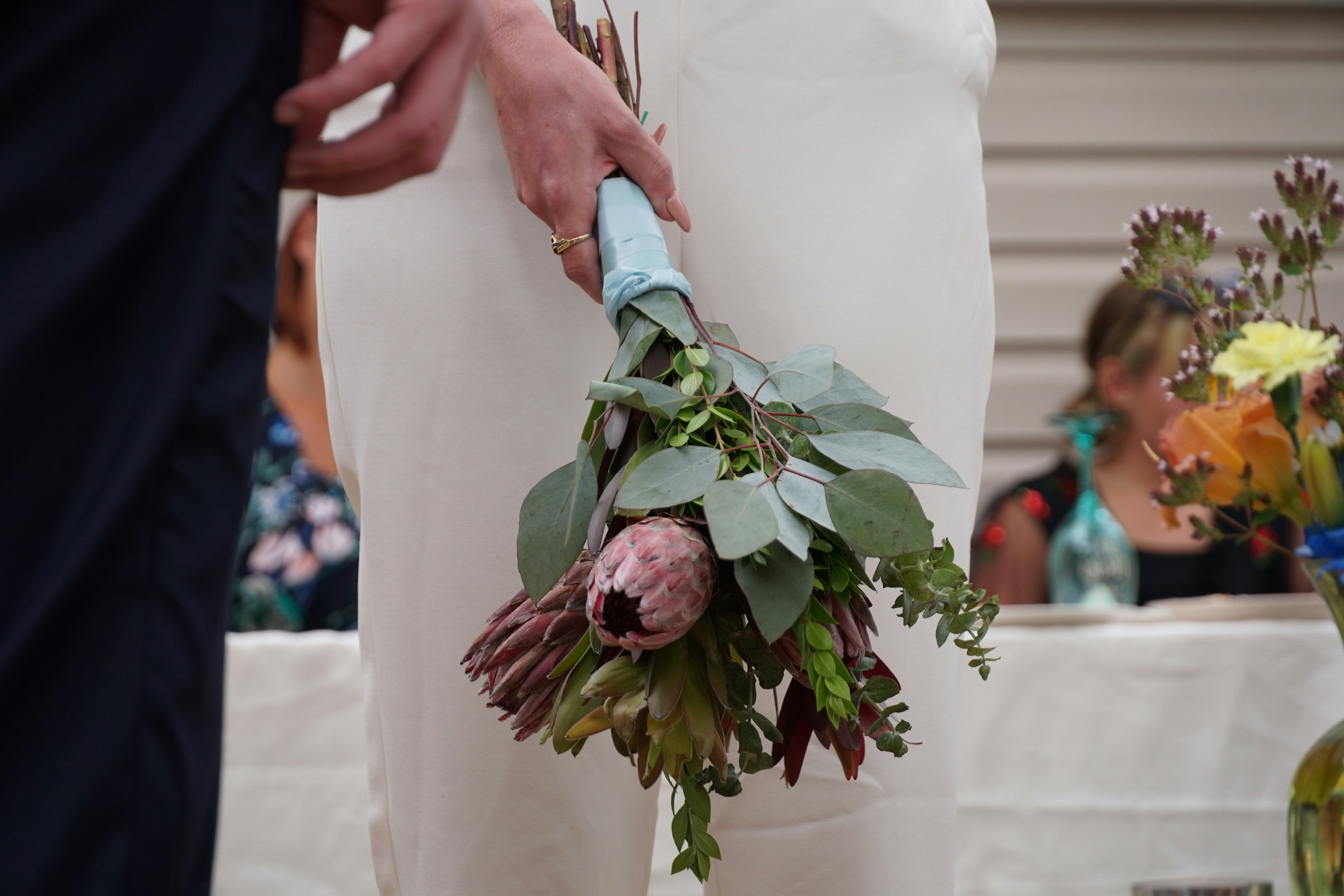 a person holding a bouquet of flowers in their hands