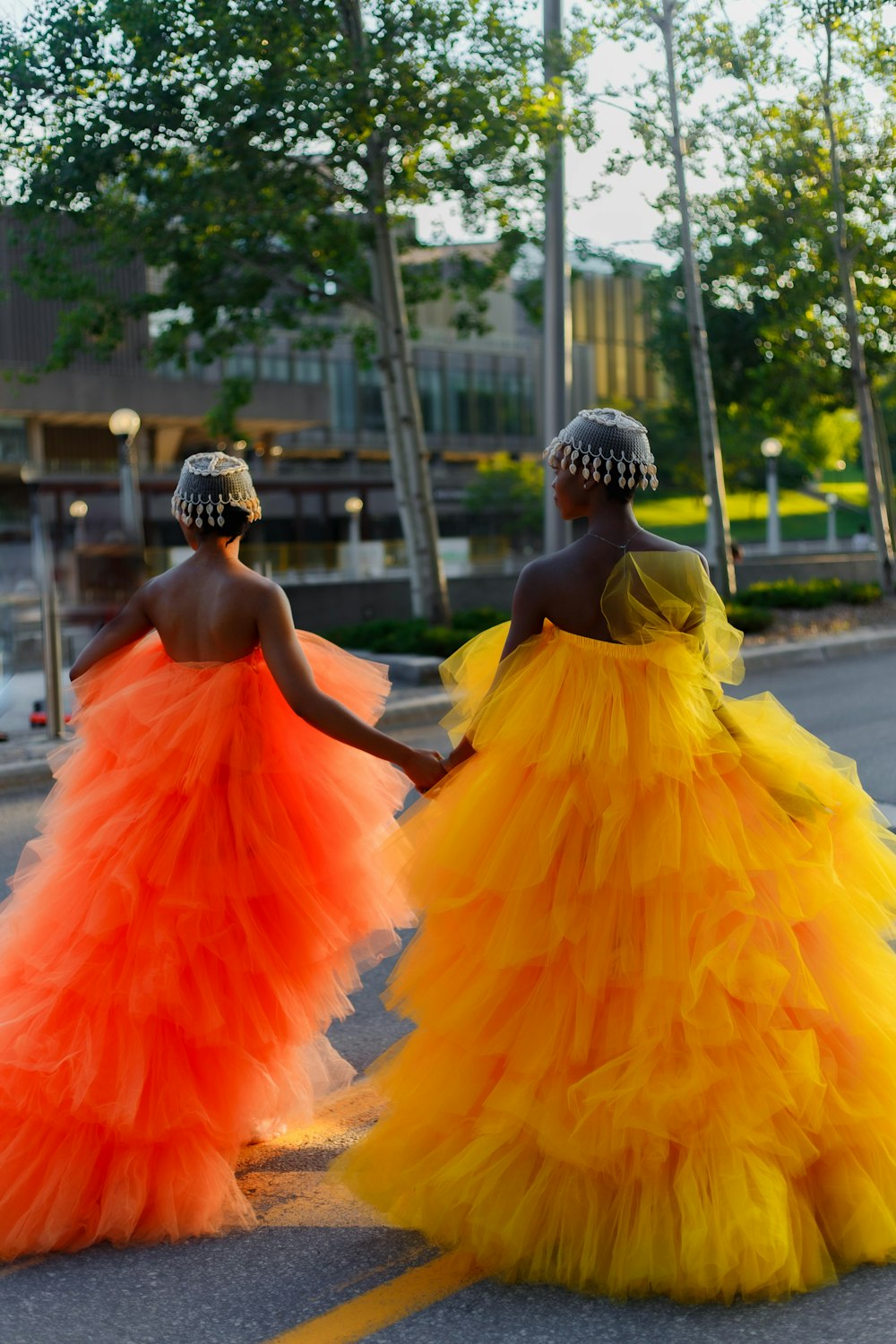 a couple of women walking down a street holding hands