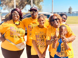 A group photo of people wearing vitamisión t-shirts at a community outreach event.