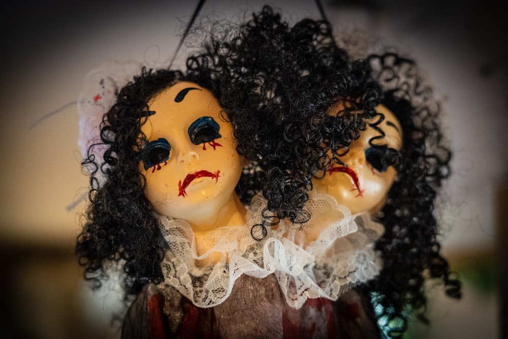 a couple of creepy dolls hanging from a string