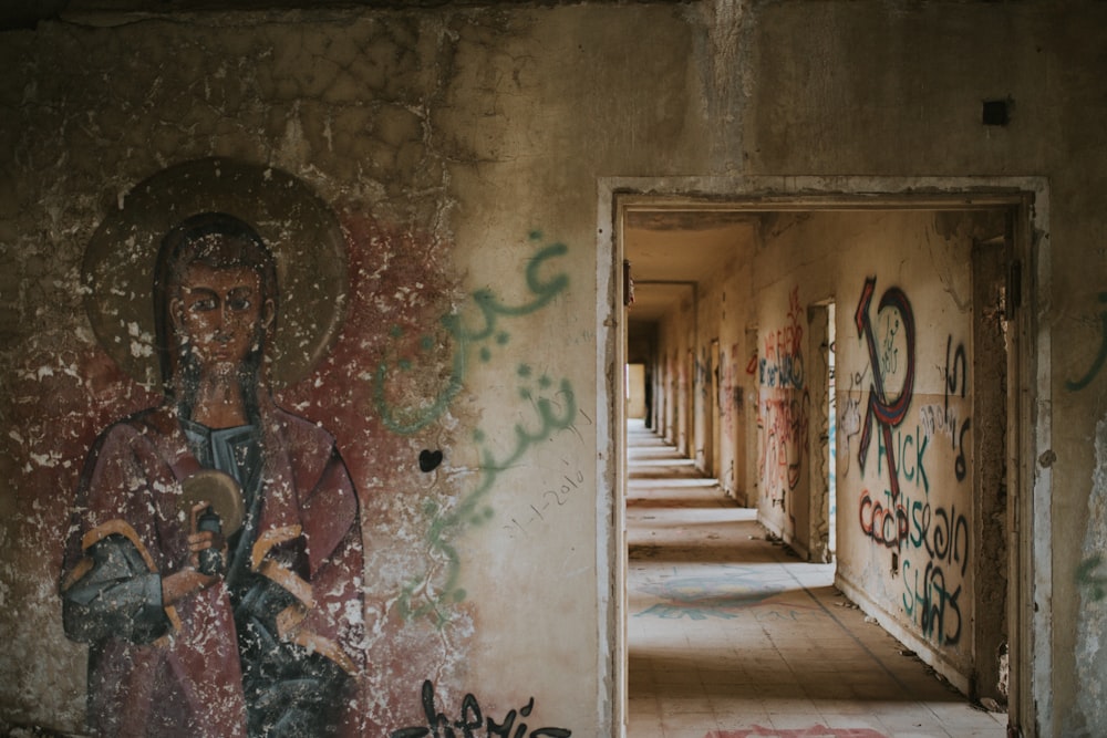 a hallway with a painting of a woman holding a baby